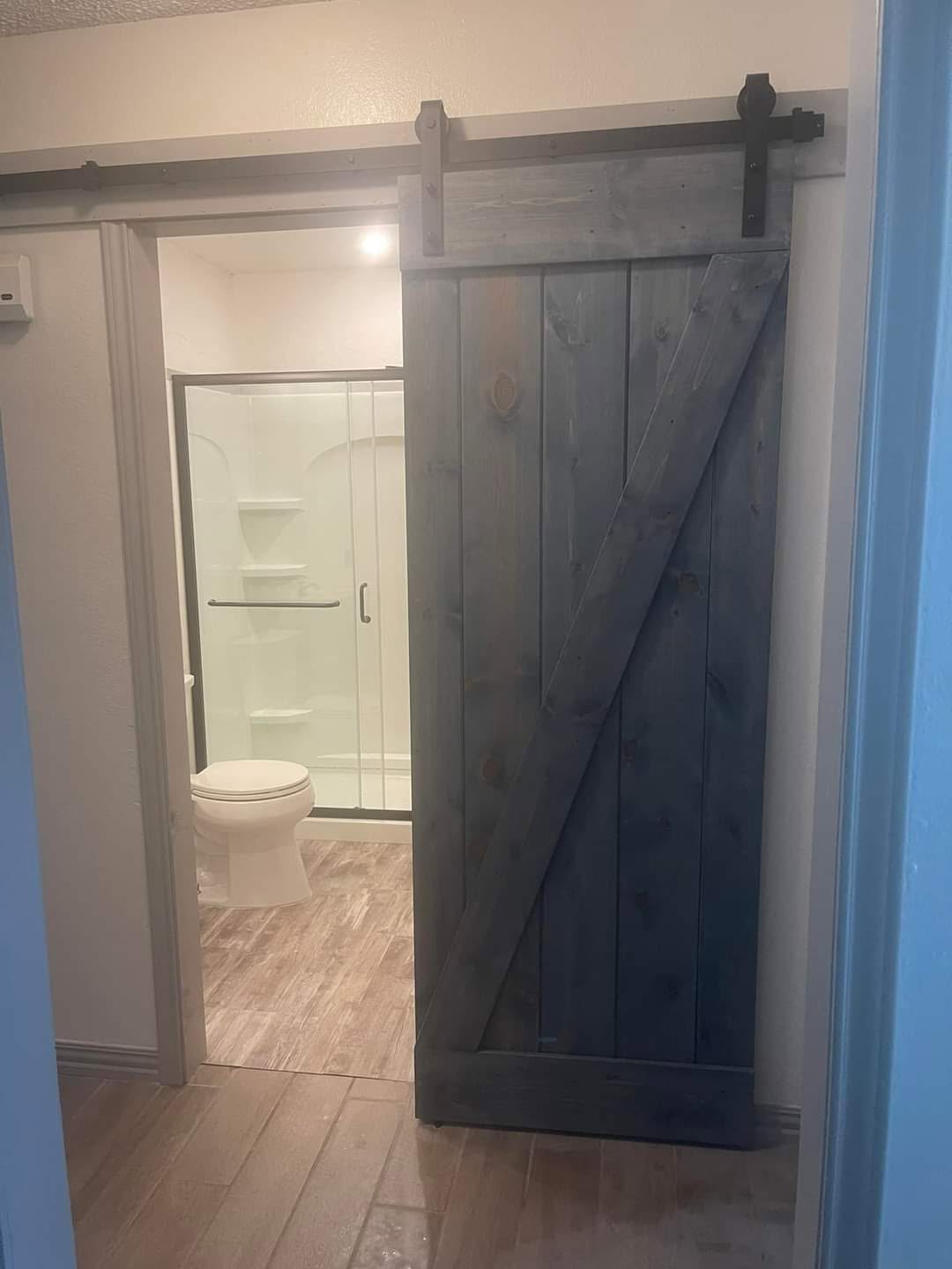 Sliding timber barn door with track hardware