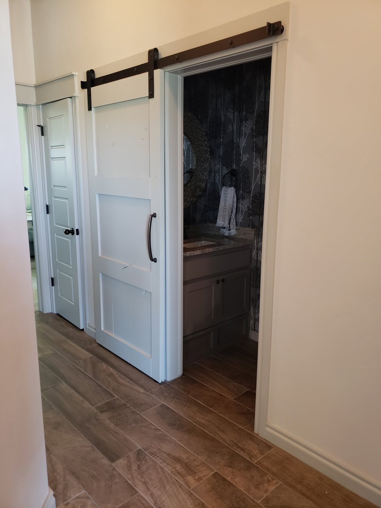 Header board backing track mount for sliding barn door