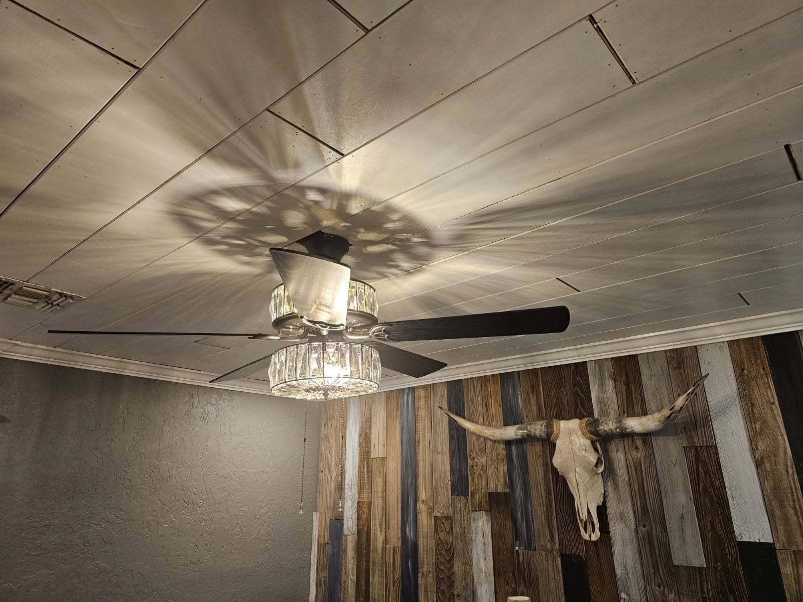 Wood plank ceiling with decorative timber beams