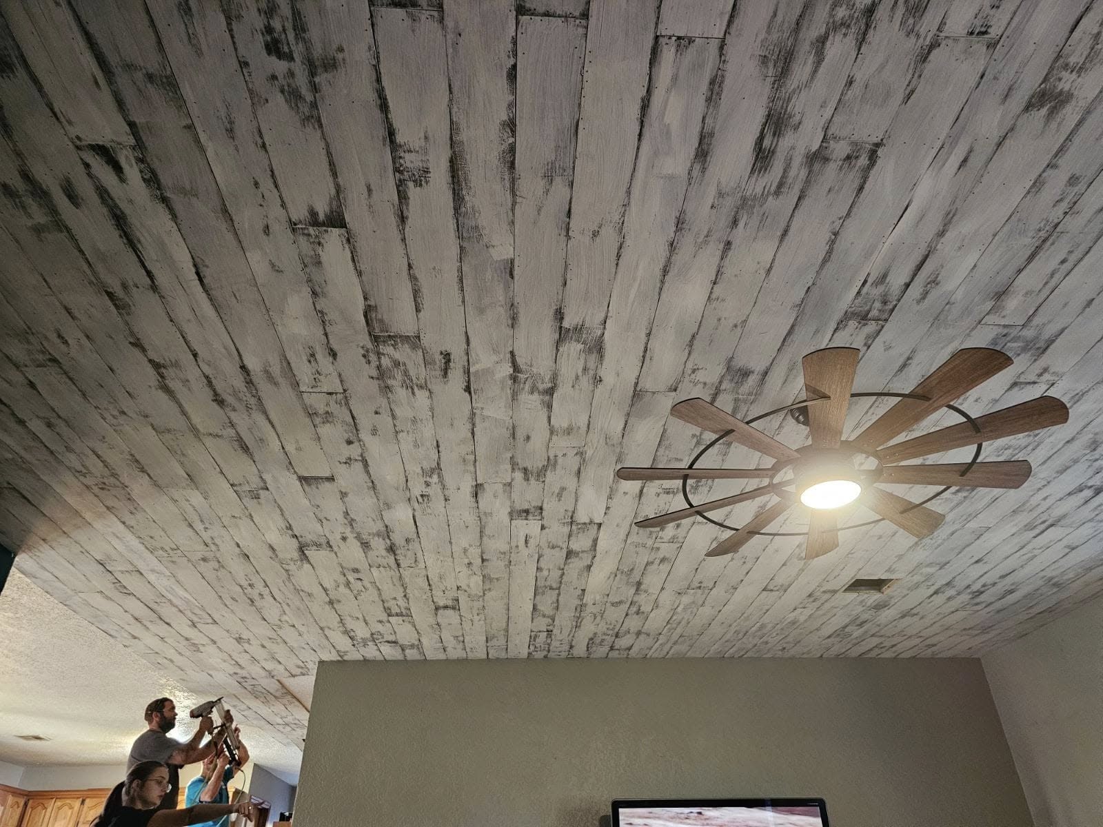 Custom wood ceiling with ceiling fan and tongue-and-groove planks